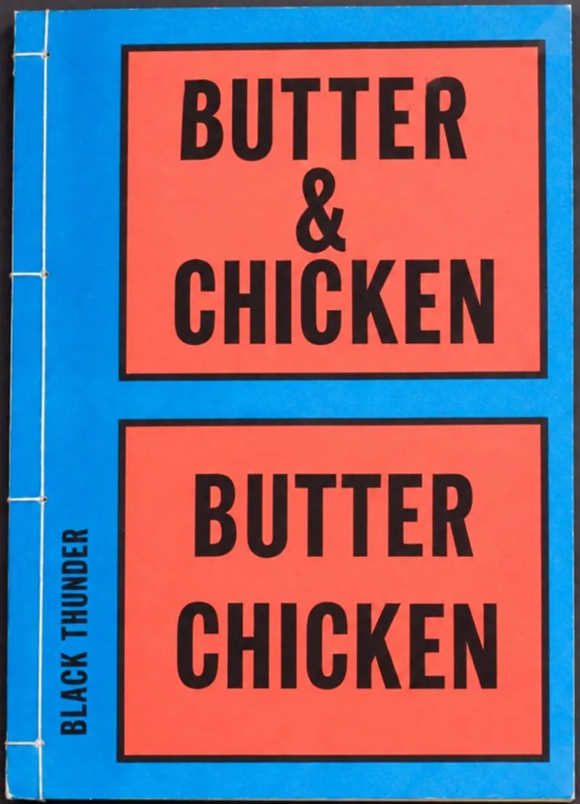 Stab-bound book with a blue cover and two red panels reading Butter & Chicken and Butter Chicken, Black Thunder on the spine